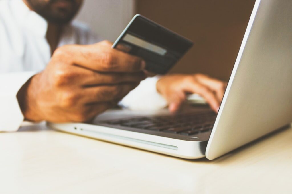 A man using a credit card for an online purchase.